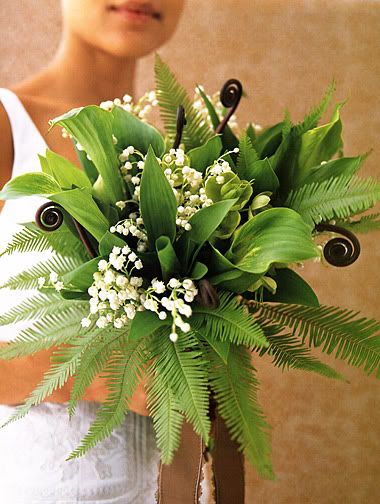  and white bouquet that includes lily of the valley and fiddlehead ferns.