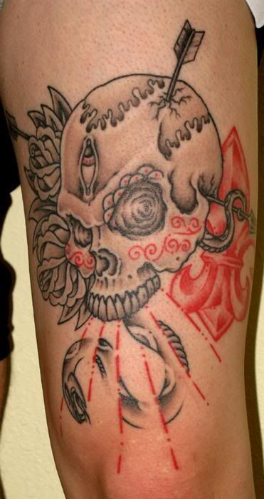 Colorful skull and dagger tattoo with flames.